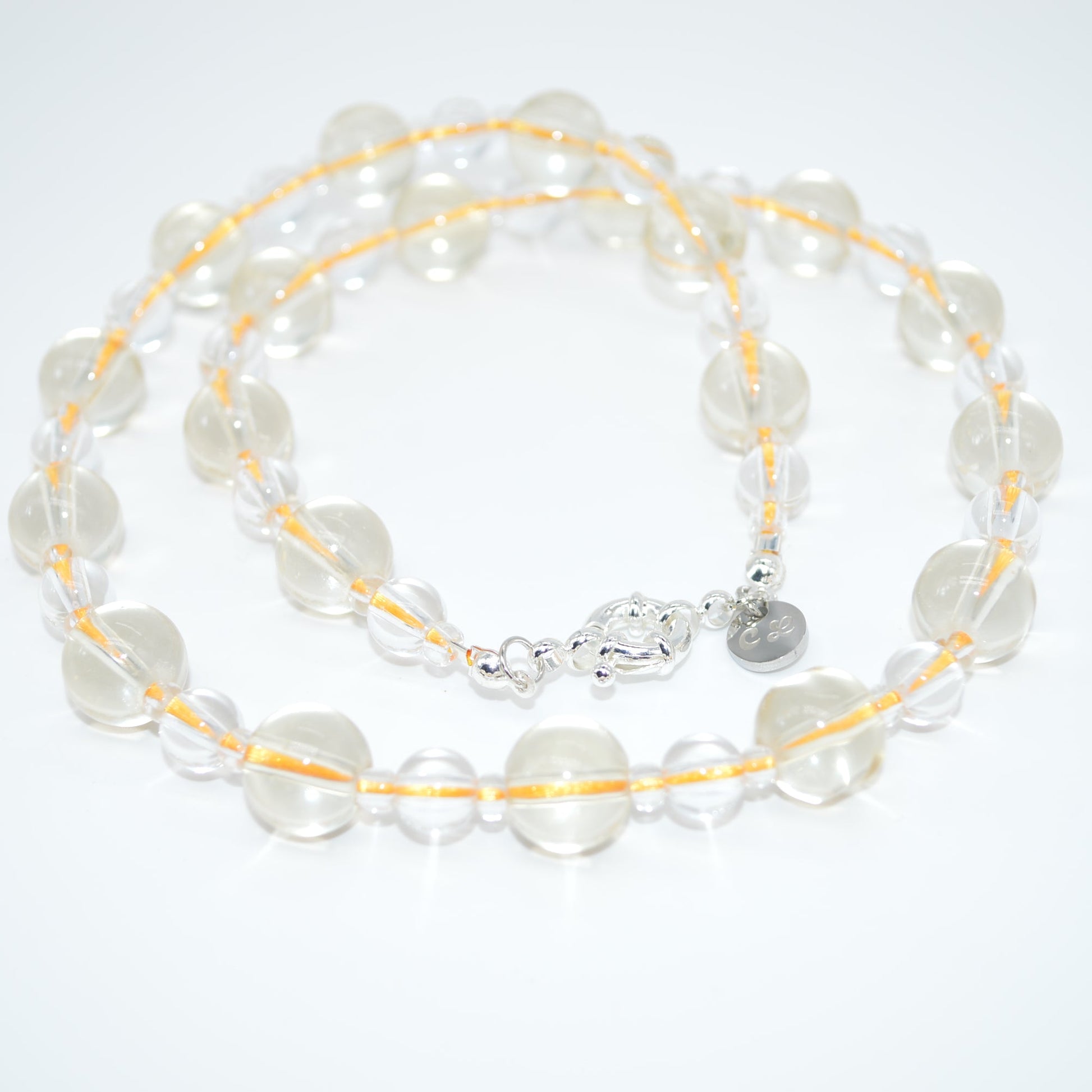 clear and yellow necklace on a white background