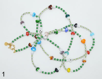 Set of colorful beaded necklaces on a white background