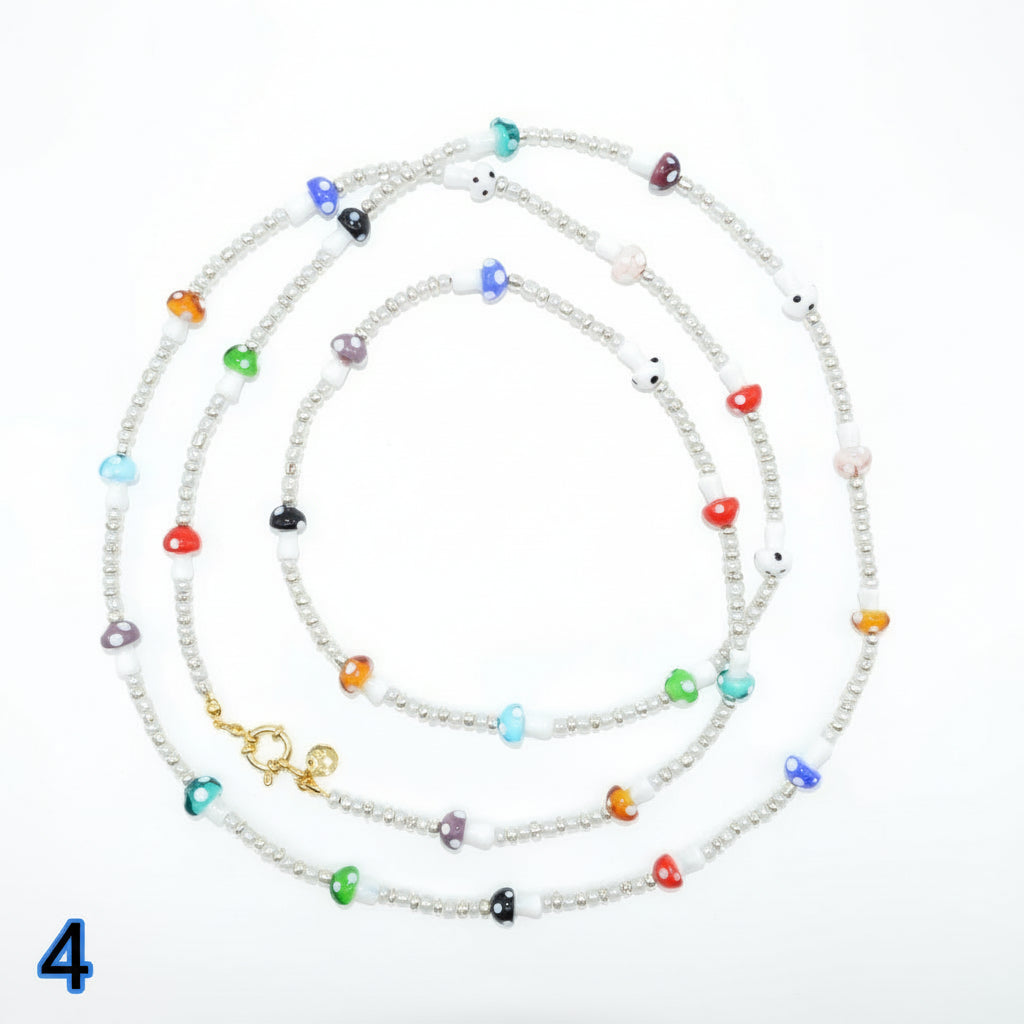 Set of colorful beaded necklaces on a white background