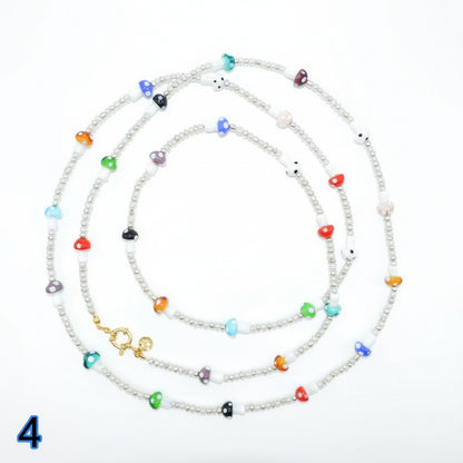 Set of colorful beaded necklaces on a white background