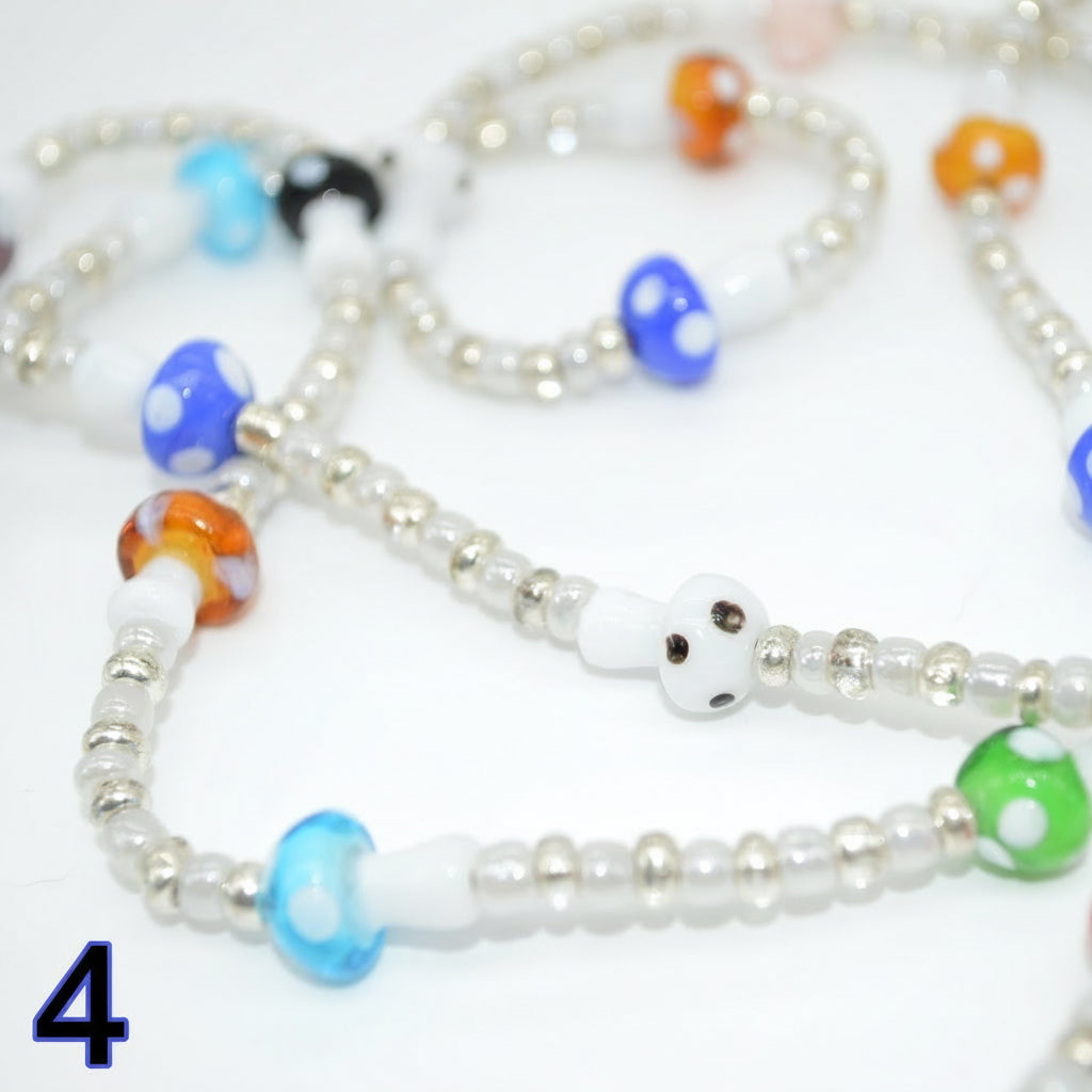 Colorful beaded necklace with variously shaped beads on a white background