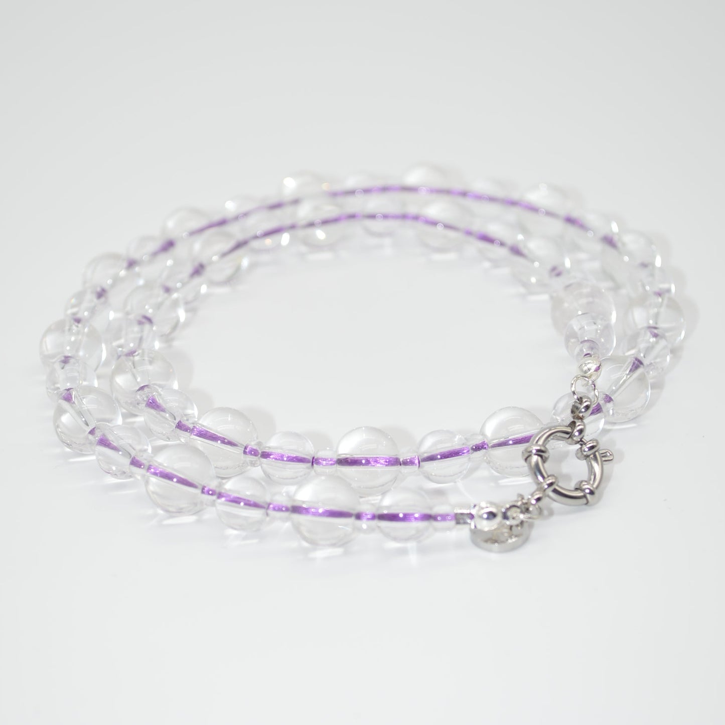 Beaded necklace with a silver clasp on a white background