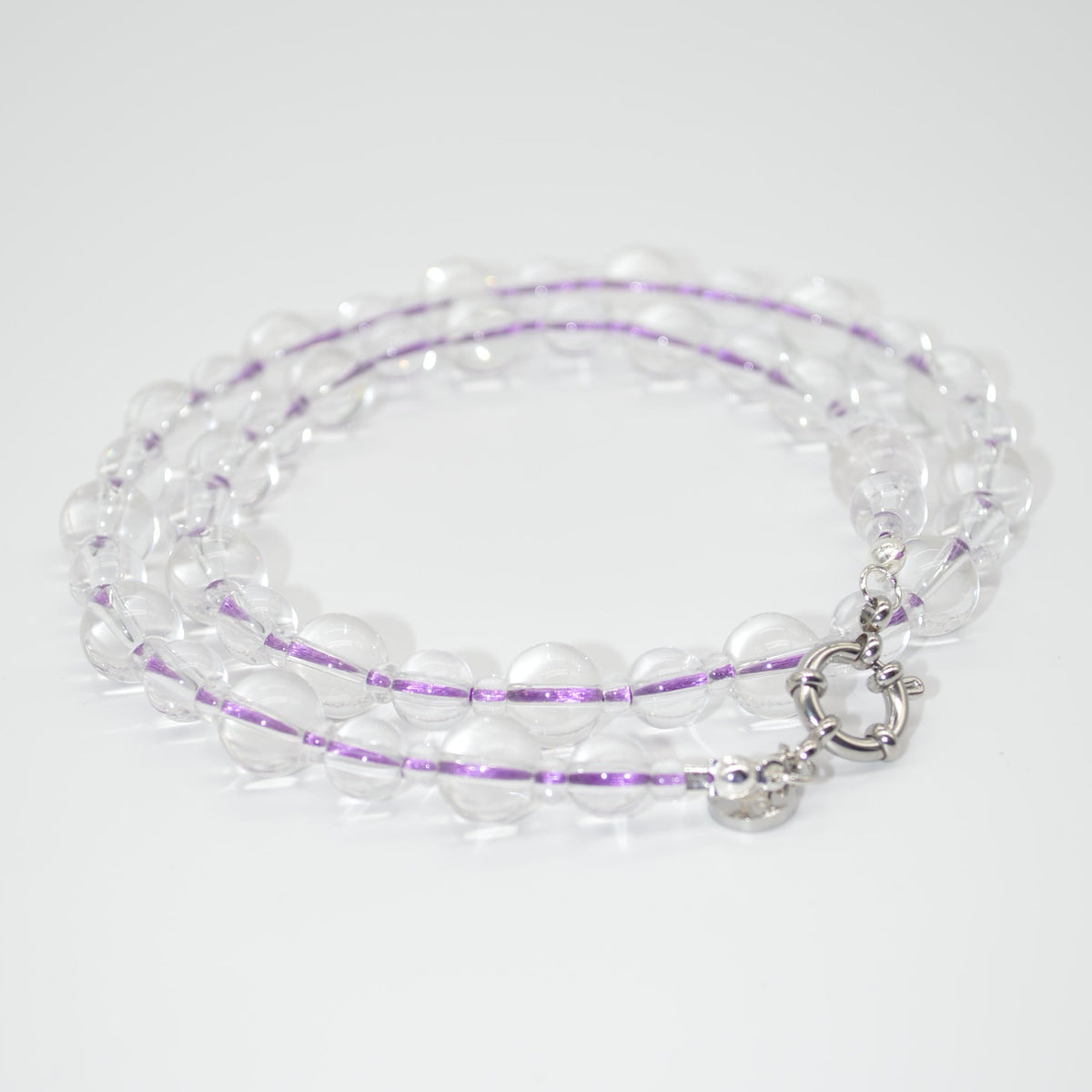 Beaded necklace with a silver clasp on a white background
