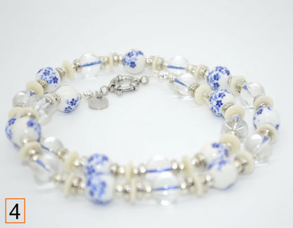 Necklace with blue and white floral pattern on a light gray background