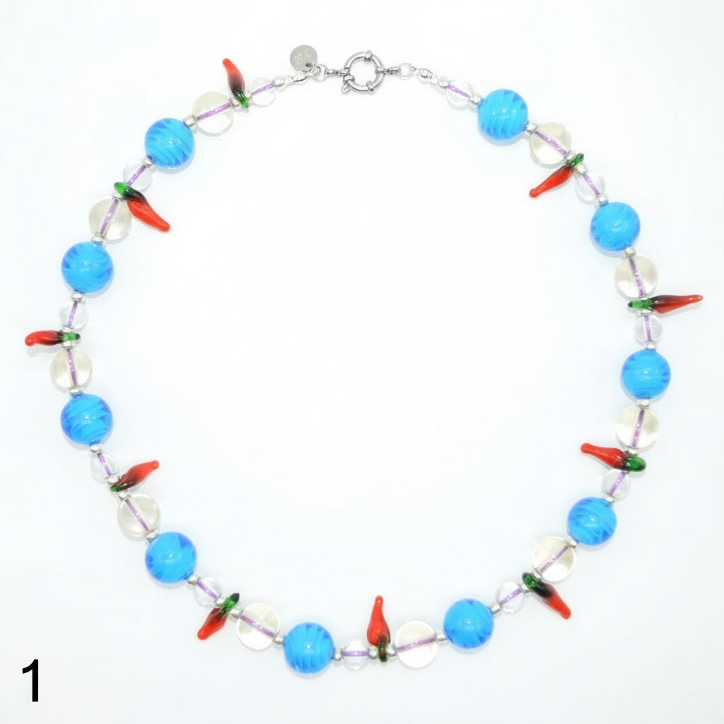 Necklace with blue, red, and clear beads on a white background