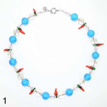 Necklace with blue, red, and clear beads on a white background