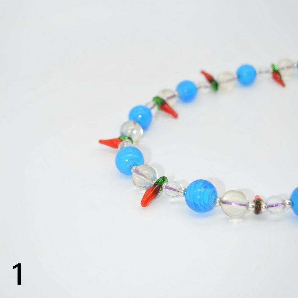 Necklace with blue, white, and multicolored beads on a white background