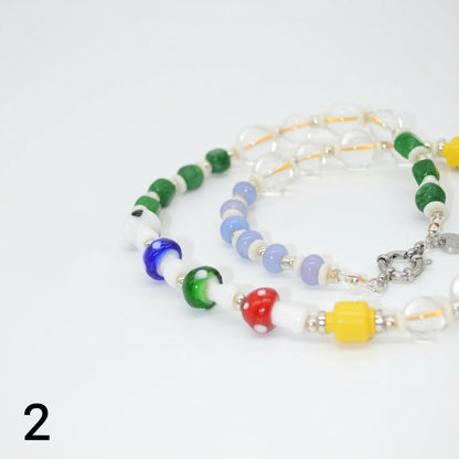 Colorful beaded bracelets on a white background