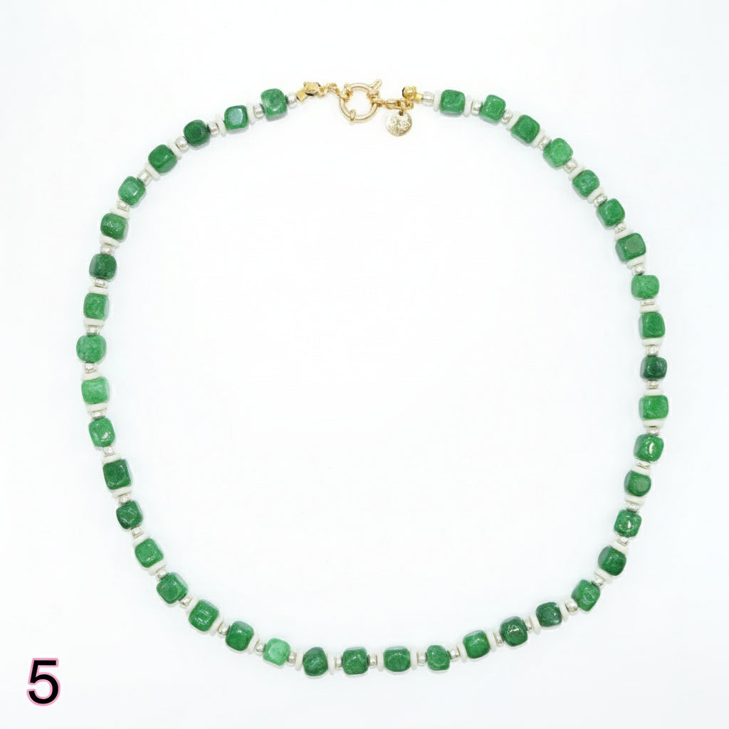 Green beaded necklace with a gold clasp on a white background