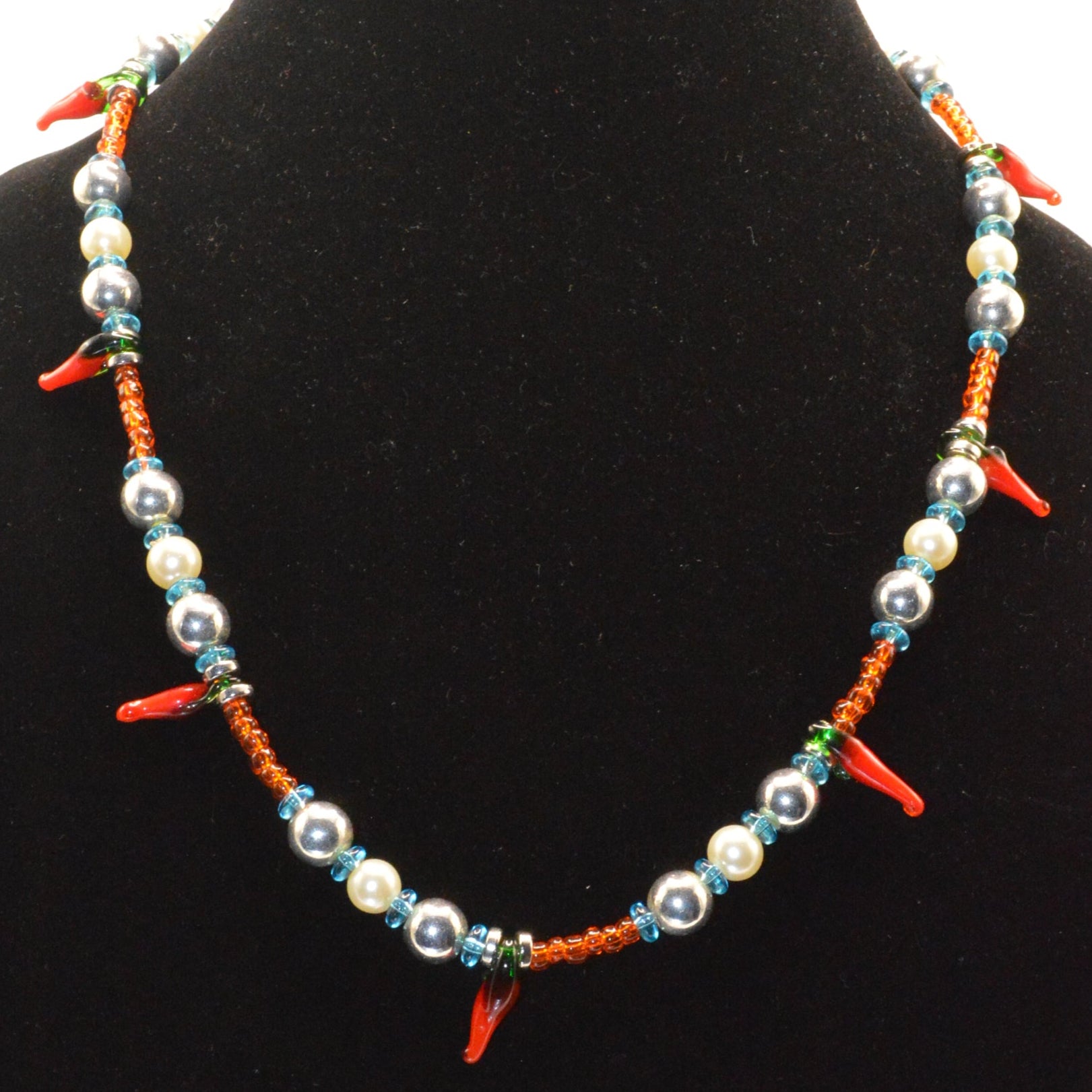 Colorful beaded necklace on a black velvet stand