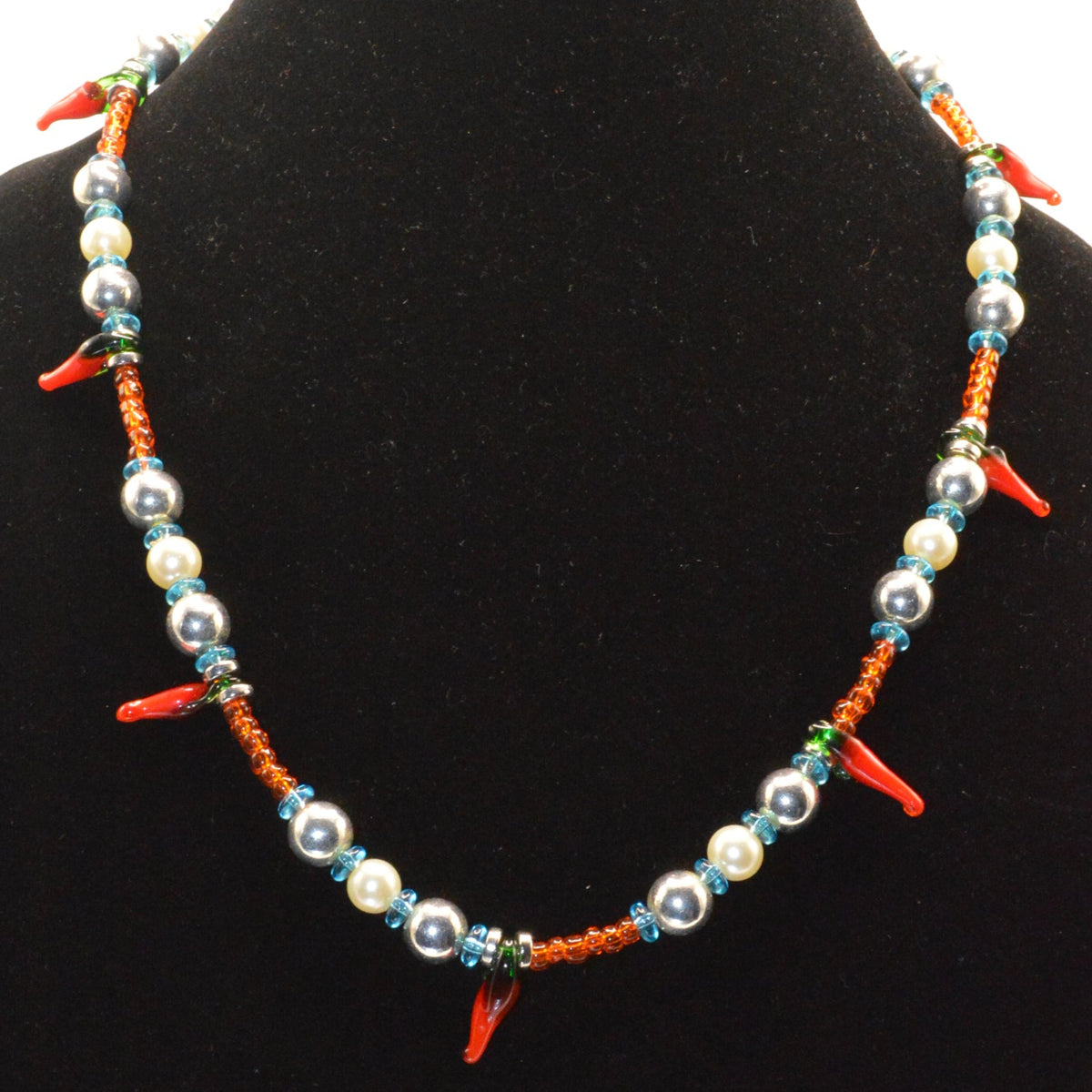Colorful beaded necklace on a black velvet stand