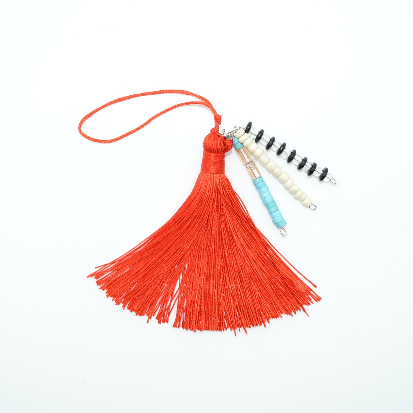 Red tassel with a small notebook on a white background