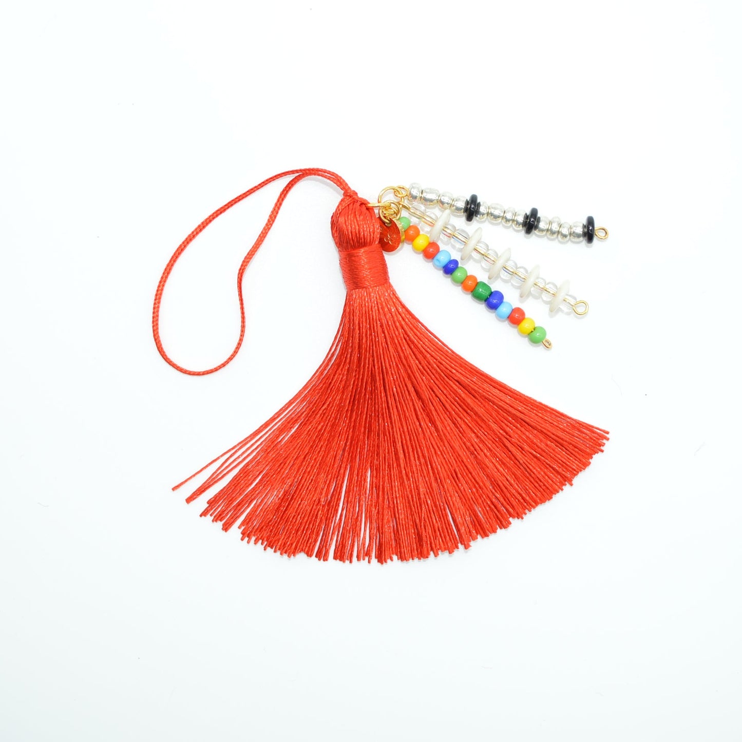 Red tassel with colorful beads on a white background