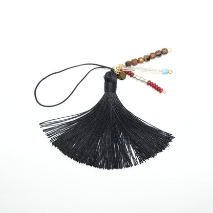 Black tassel with beads on a white background