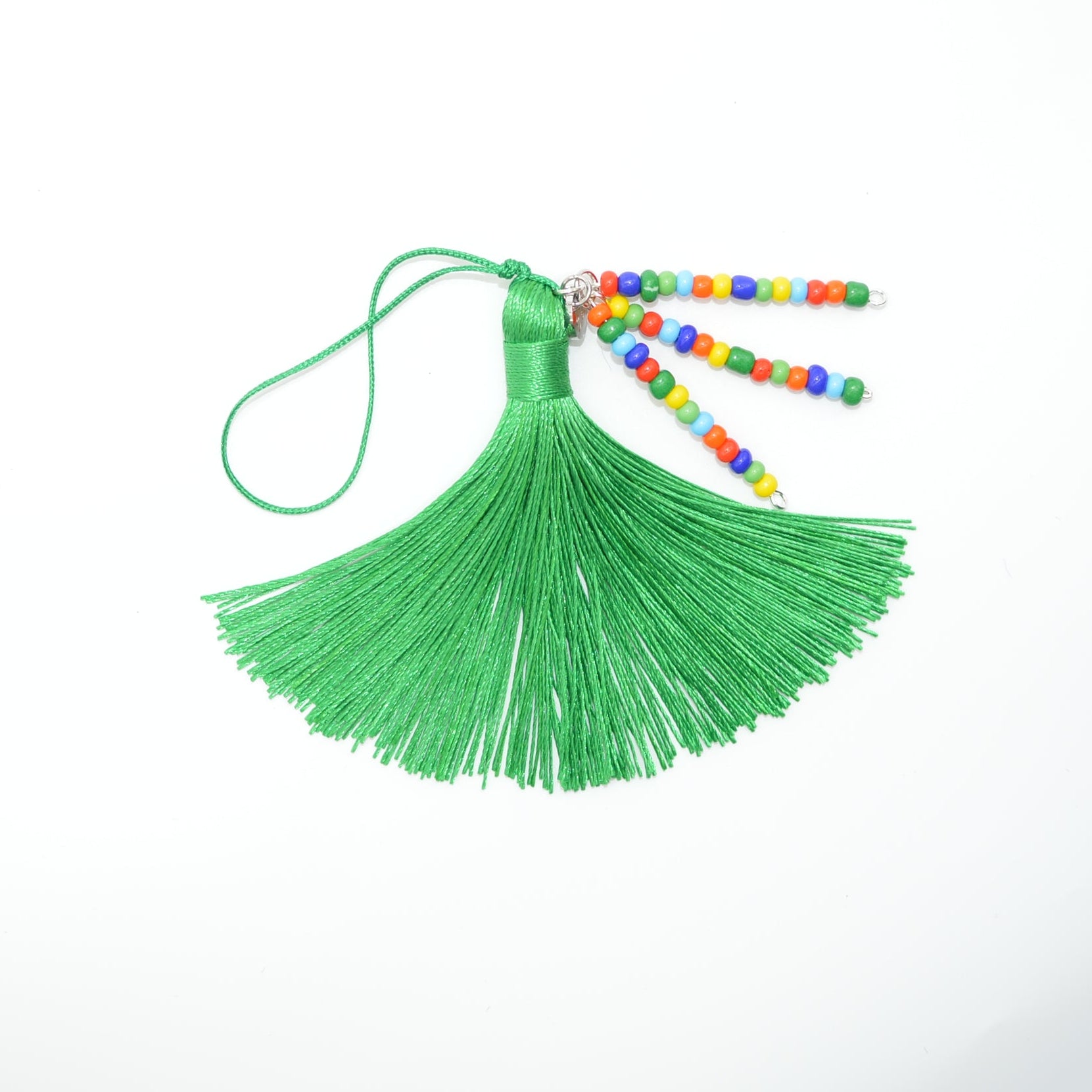 Green tassel with colorful beads on a white background