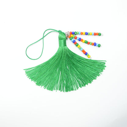 Green tassel with colorful beads on a white background