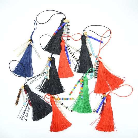 Colorful tassels with beads on a white background