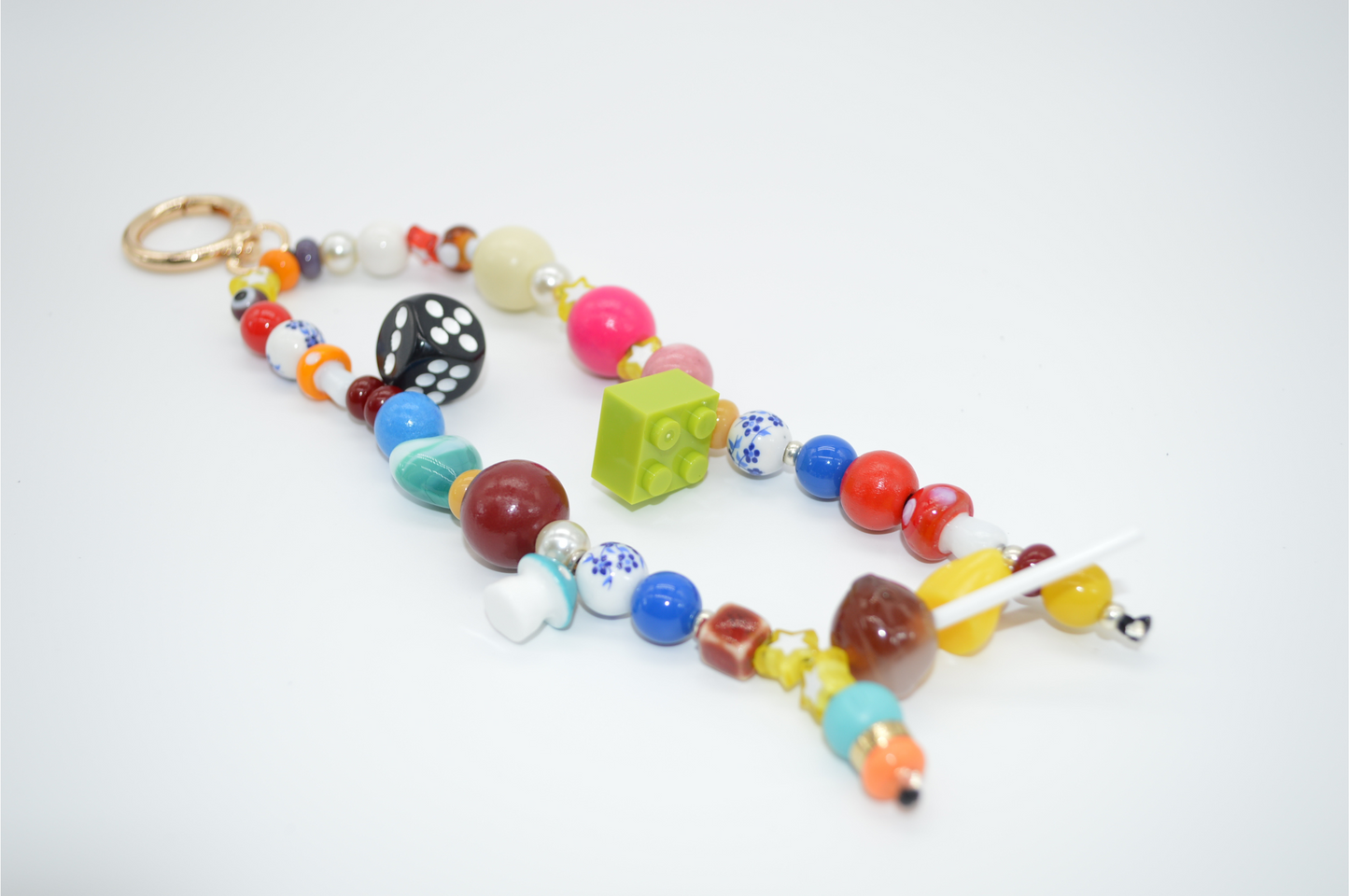 Colorful beaded keychain with a LEGO piece on a white background