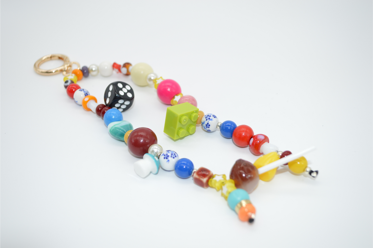 Colorful beaded keychain with a LEGO piece on a white background
