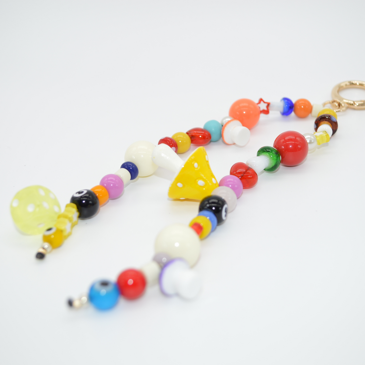 Colorful beaded keychain with various shapes on a white background