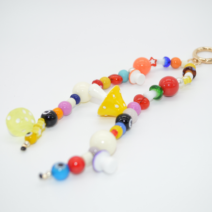 Colorful beaded keychain with various shapes on a white background