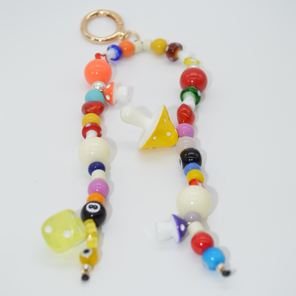 Colorful beaded keychain with geometric shapes on a white background