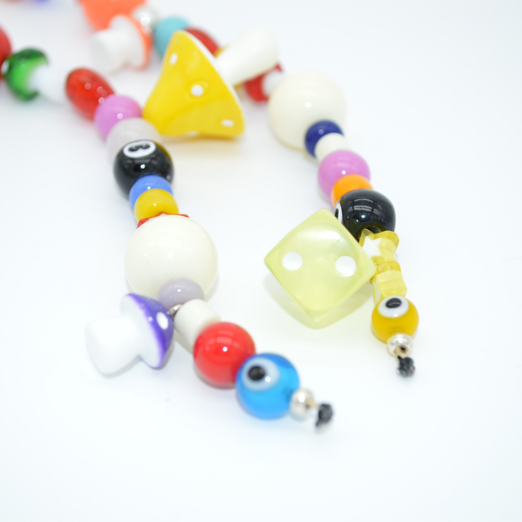 Colorful beaded necklace with various shapes on a white background