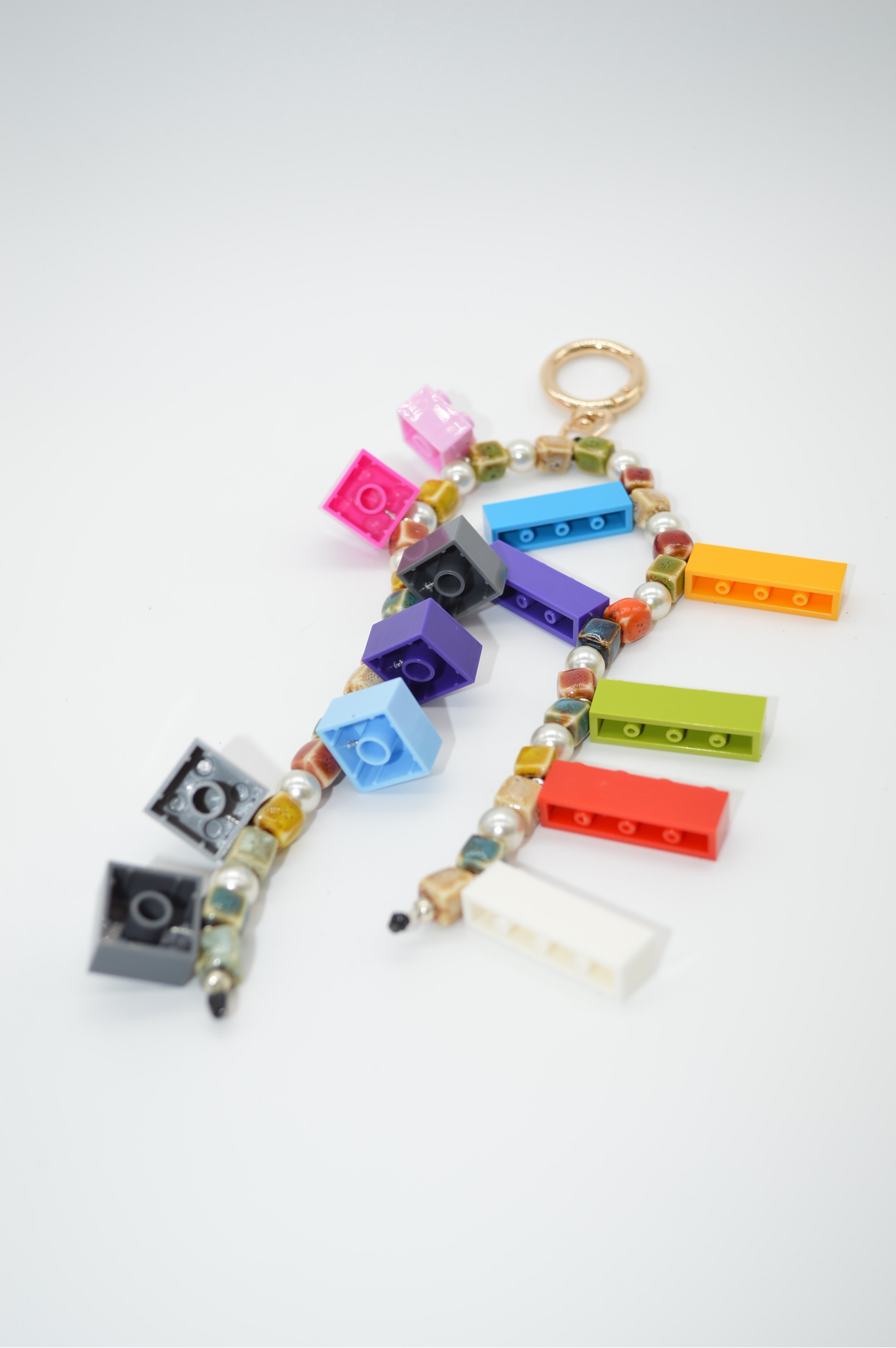 Colorful keychain made of interlocking brick pieces on a white background