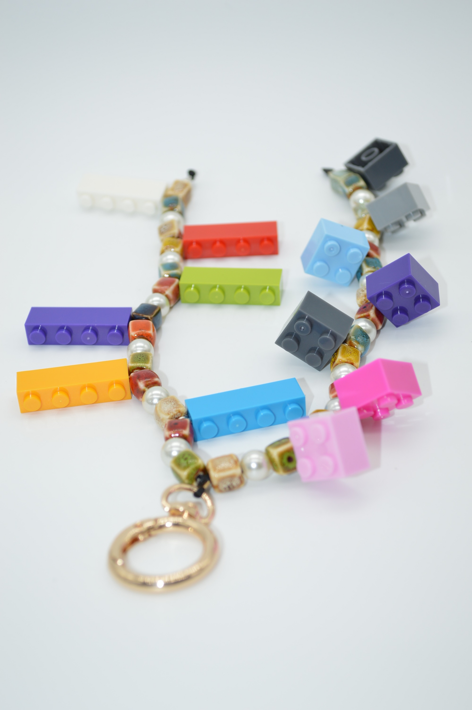 Colorful keychain with LEGO brick-shaped beads on a white background