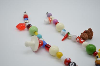 Colorful necklace with various shaped beads on a white background
